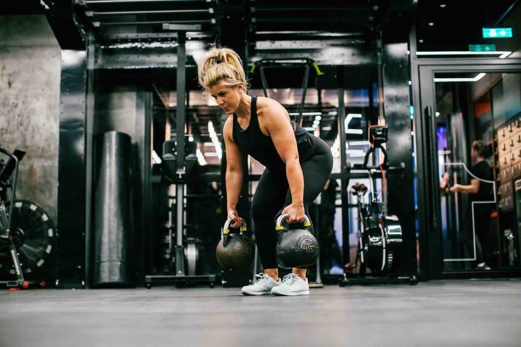 Laura Hoggins holding kettle bells