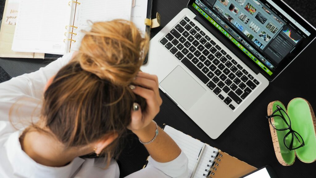 stressed person with head in hands